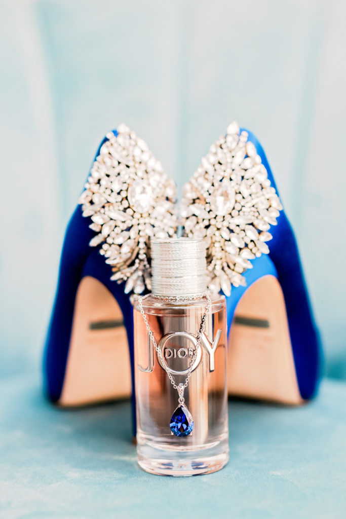 Royal blue wedding day shoes with embellishments pump in blue satin photo with bridal perfume and jewelry 