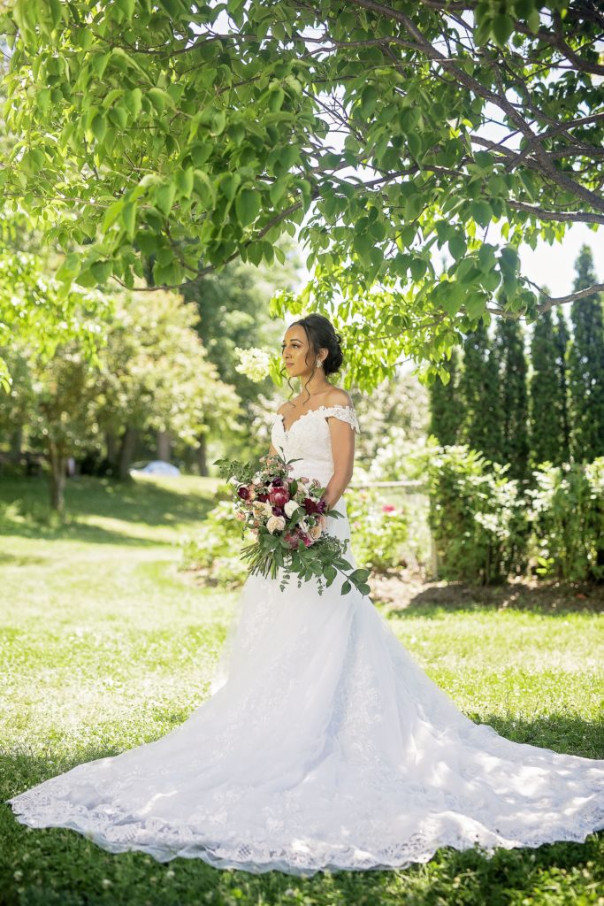 Asmeret Bridal Portrait Under tree flowing train off the shoulder wedding dress bouquet with pink and white flowers