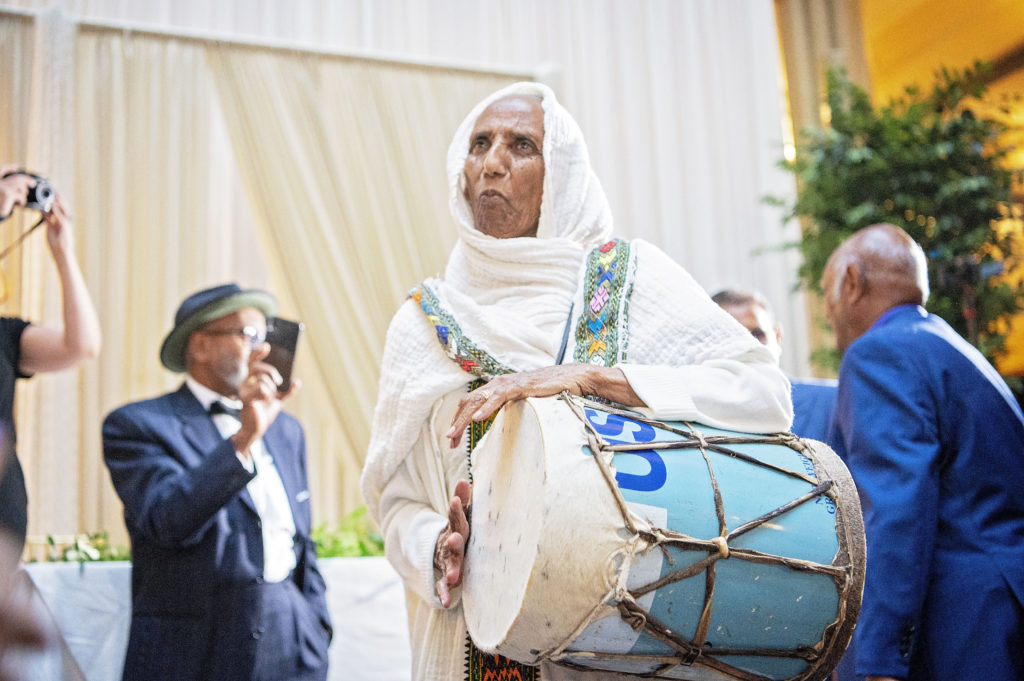 Welcome procession before the couple enters playing a drum ethiopian wedding minnesota