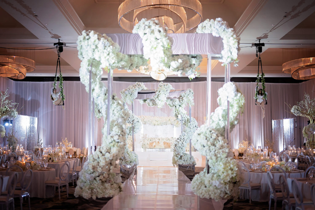 The Post Oak Hotel Wedding Reception hall large floral arcs, acrobats, extravagant decor Houston Texas 