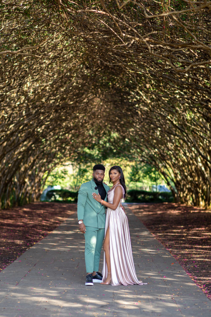 intimate photo with engaged couple in engagement shoot under natural tree canopy 