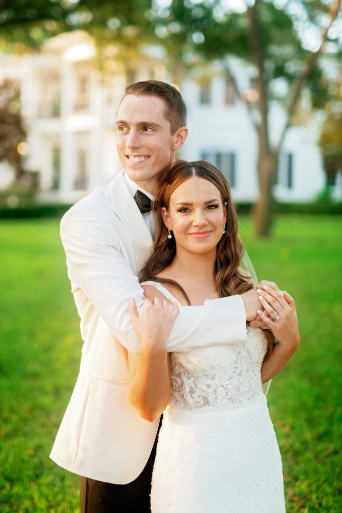 bride and groom smile together in each other's arms