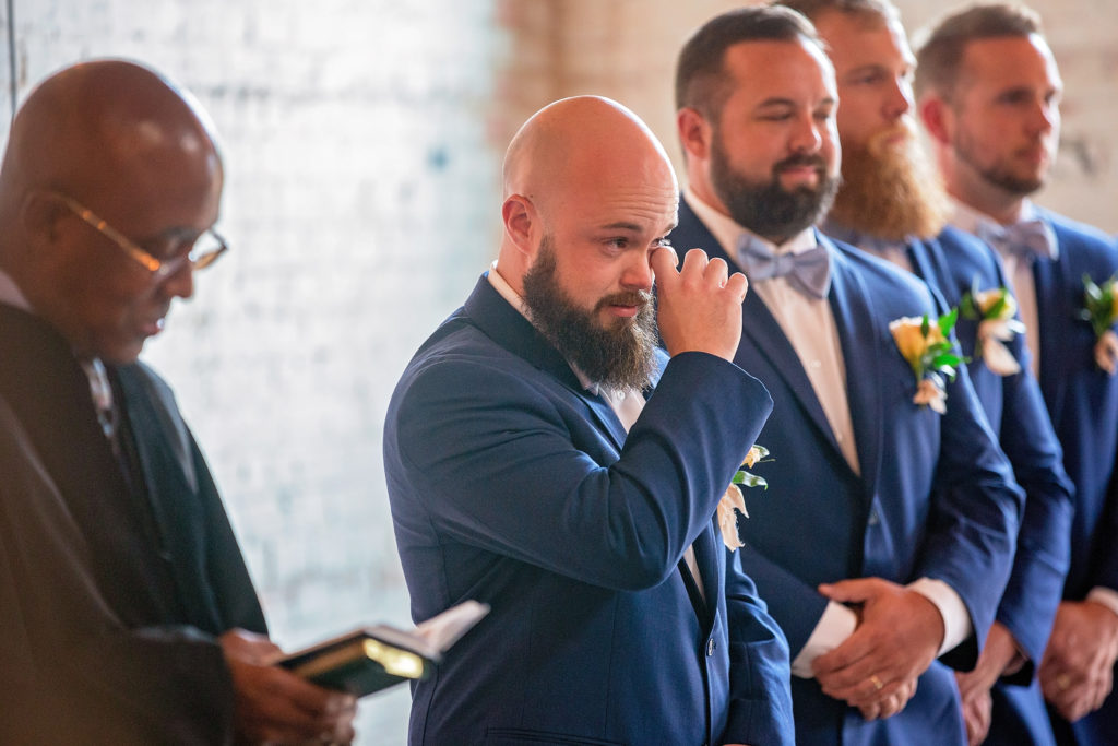 emotional groom moment looking at the bride at Brake and Clutch Warehouse wedding