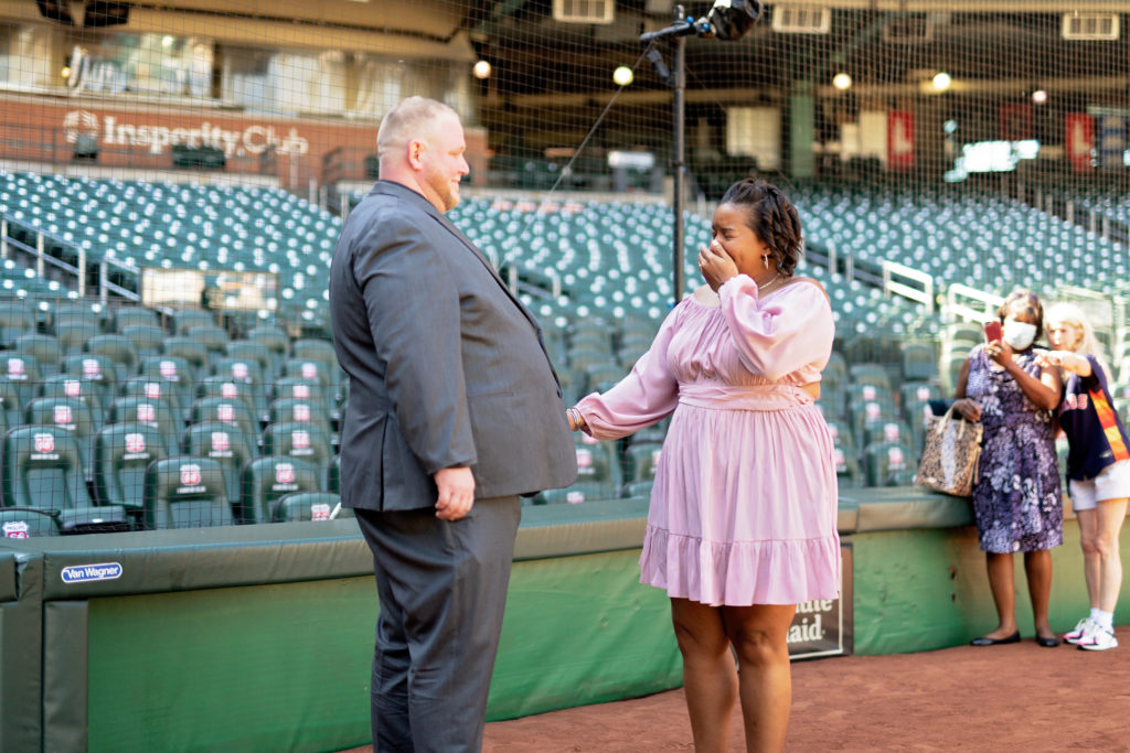 emotional engagement proposal at Minute Maid Park with friends and family  