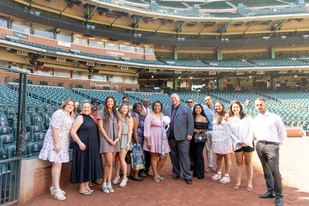 friends and family at engagement proposal in Minute Maid Park