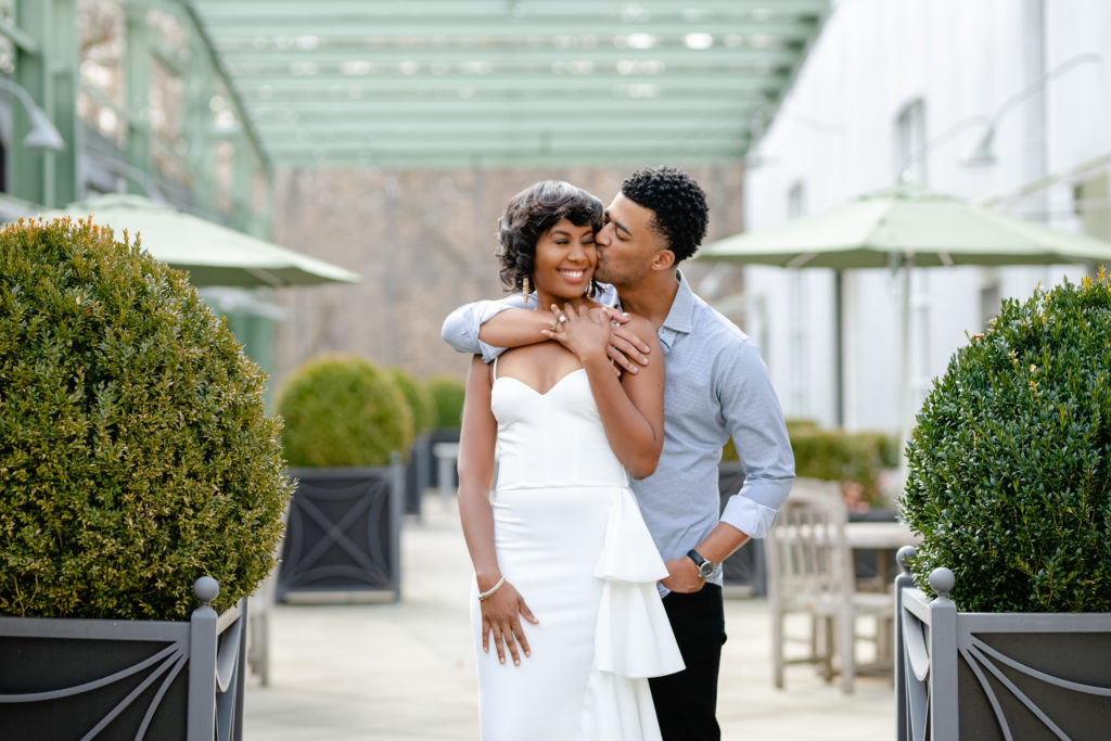 Outdoor engagement session, white engagement dress, men engagement outfit, greenery, couple posing