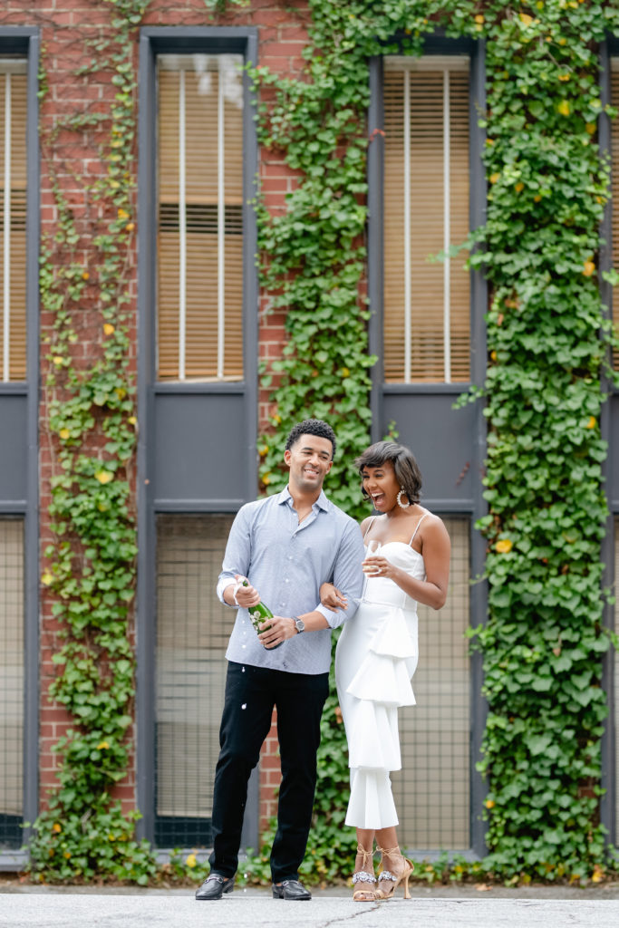 Outdoor photoshoot, outdoor engagement session, couple posing, white dress engagement, greenery backdrop