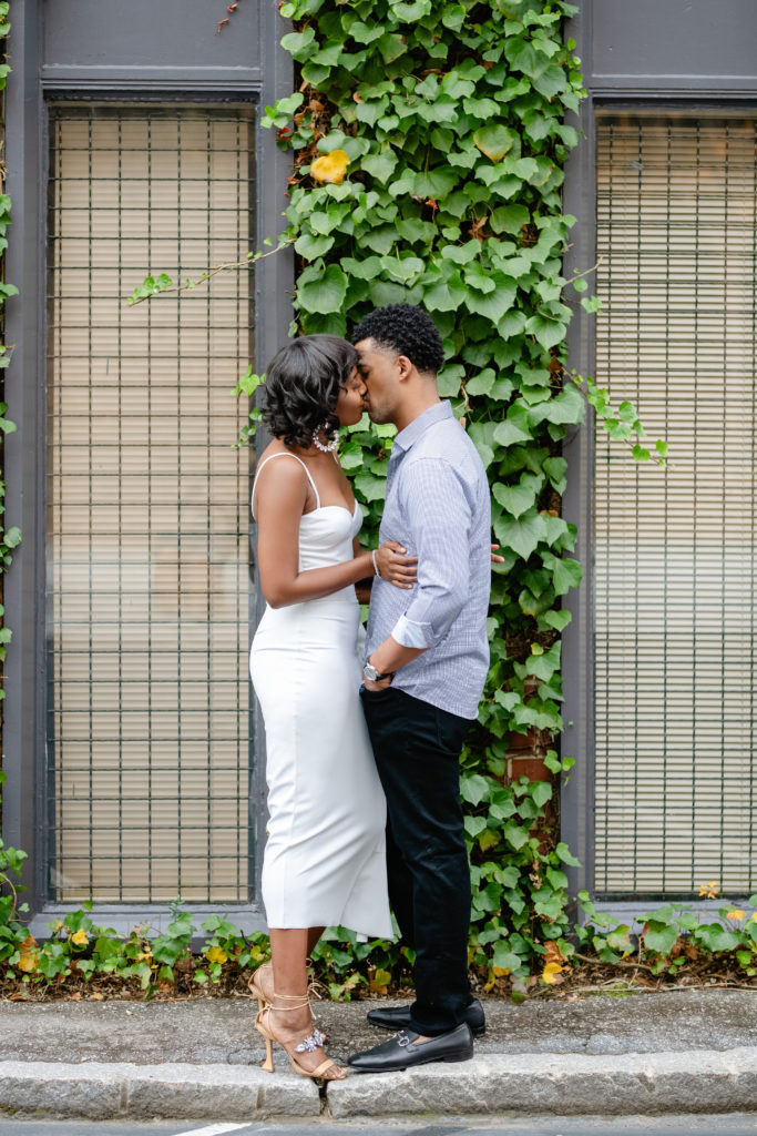 Outdoor photoshoot, outdoor engagement session, kissing posing, white dress engagement, greenery backdrop