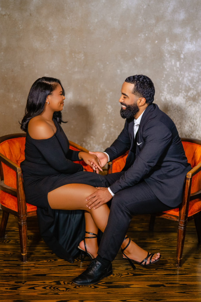 Engagement session, couple poses, loft location, houston photoshoot, black couple, all black attire , glamour engagement outfit, sitting down poses